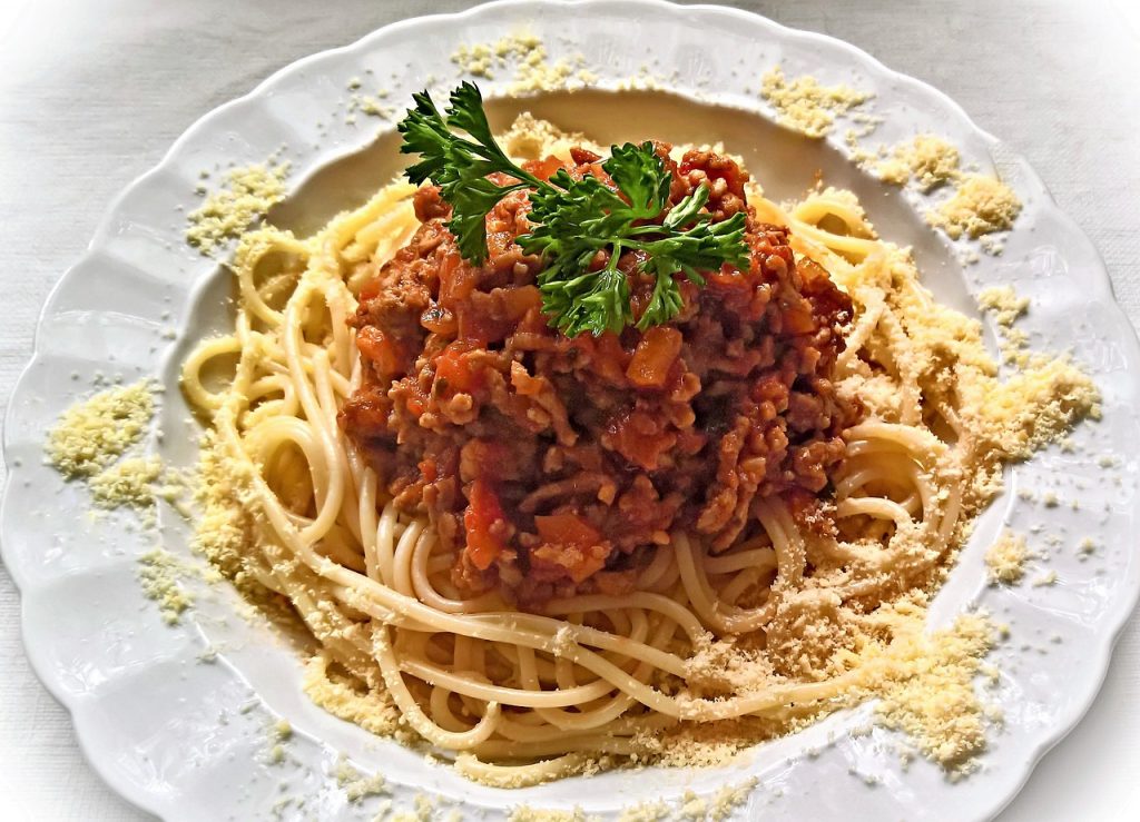 spaghetti bolognese, italian court, grated parmesan cheese